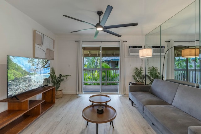 480 Kenolio Rd Unit 24-202, Kihei, HI 96753 - living room with ceiling fan, wood finished floors, baseboards, and a wall mounted air conditioner