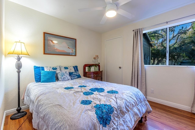 bedroom with hardwood / wood-style floors and ceiling fan