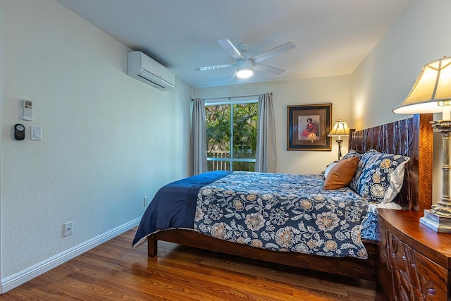 bedroom featuring ceiling fan, dark wood-type flooring, and a wall unit AC