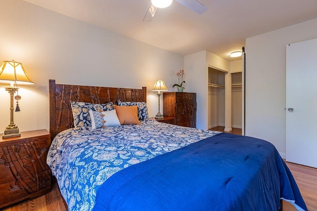 bedroom with hardwood / wood-style floors, ceiling fan, and a closet