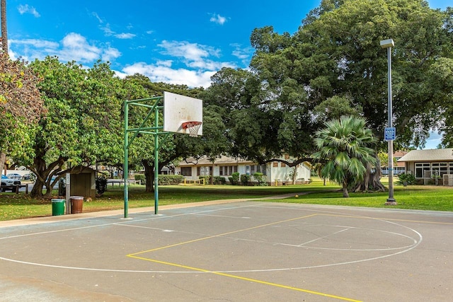 view of basketball court with a yard