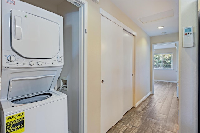 10 Polohina Ln Unit 2-3, Lahaina, HI 96761 - laundry area with stacked washing machine and dryer, wood finished floors, and baseboards