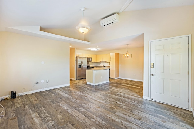 10 Polohina Ln Unit 2-3, Lahaina, HI 96761 - unfurnished living room with a wall unit AC, dark wood-style flooring, and baseboards
