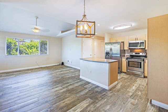 10 Polohina Ln Unit 2-3, Lahaina, HI 96761 - kitchen featuring appliances with stainless steel finishes, light wood finished floors, hanging light fixtures, and baseboards