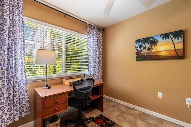 tiled home office featuring ceiling fan