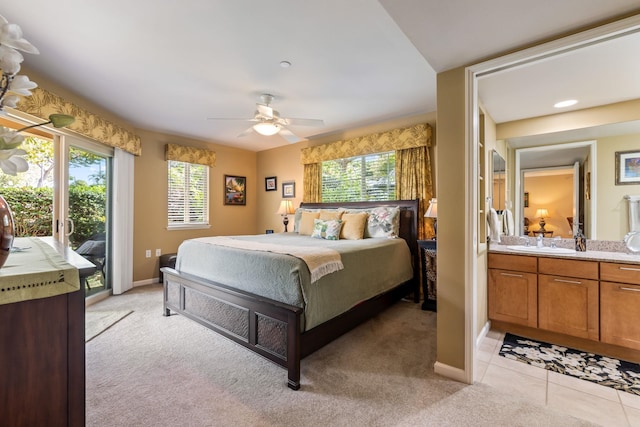 bedroom with sink, light colored carpet, access to exterior, and ceiling fan