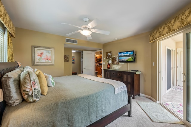 carpeted bedroom with a walk in closet, ceiling fan, and a closet