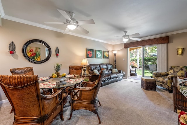 dining area featuring light carpet, ornamental molding, and ceiling fan
