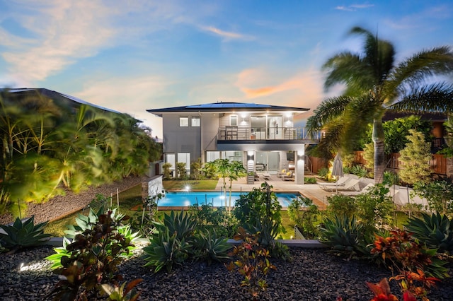 92 Kahana Ridge Dr, Lahaina, HI 96761 - rear view of house featuring a balcony, a patio, a fenced backyard, solar panels, and metal roof
