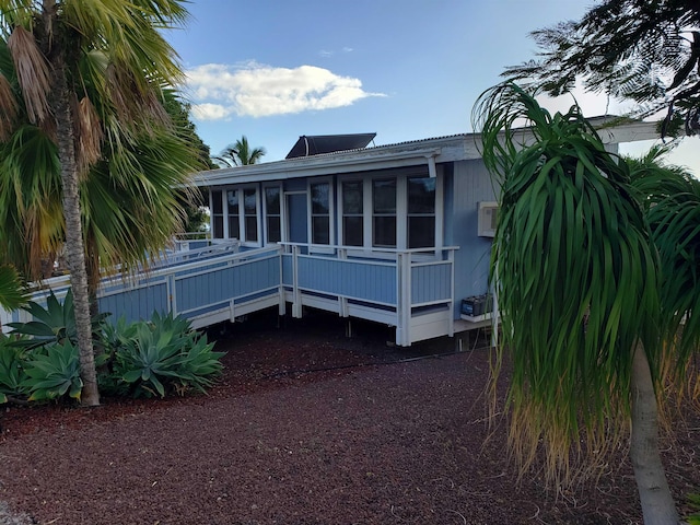 215 Aahi Pl, Kaunakakai, HI 96748 - rear view of house featuring a sunroom