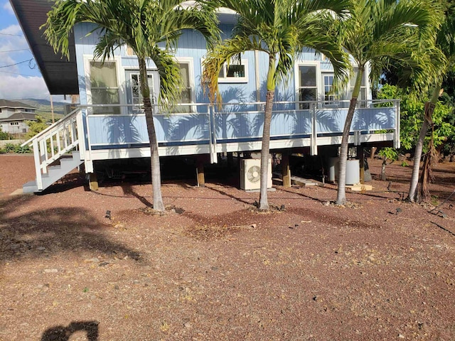 215 Aahi Pl, Kaunakakai, HI 96748 - rear view of house with a wooden deck and a cooling unit
