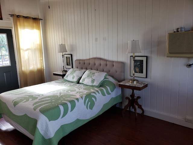 215 Aahi Pl, Kaunakakai, HI 96748 - bedroom featuring wood finished floors, a wall mounted AC, and baseboards