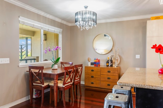 dining area with crown molding, a chandelier, and dark hardwood / wood-style flooring