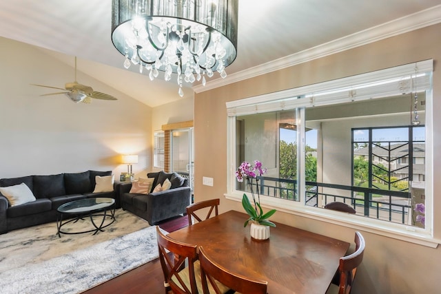 dining room with hardwood / wood-style flooring, vaulted ceiling, ornamental molding, and ceiling fan with notable chandelier