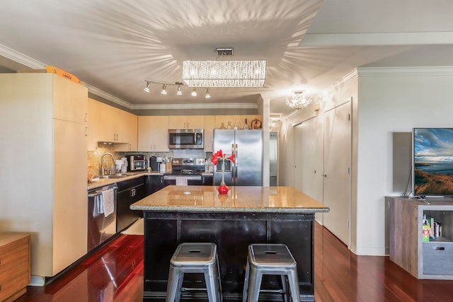 kitchen featuring a kitchen island, appliances with stainless steel finishes, sink, and dark hardwood / wood-style floors