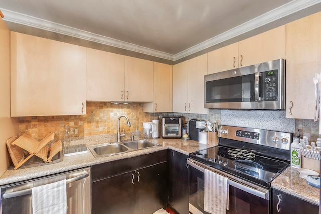 kitchen featuring crown molding, appliances with stainless steel finishes, sink, and decorative backsplash