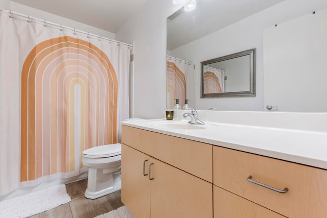 bathroom with hardwood / wood-style flooring, vanity, and toilet