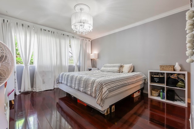 bedroom featuring crown molding, wood-type flooring, and a notable chandelier