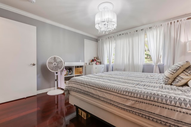 bedroom with an inviting chandelier, hardwood / wood-style floors, and ornamental molding