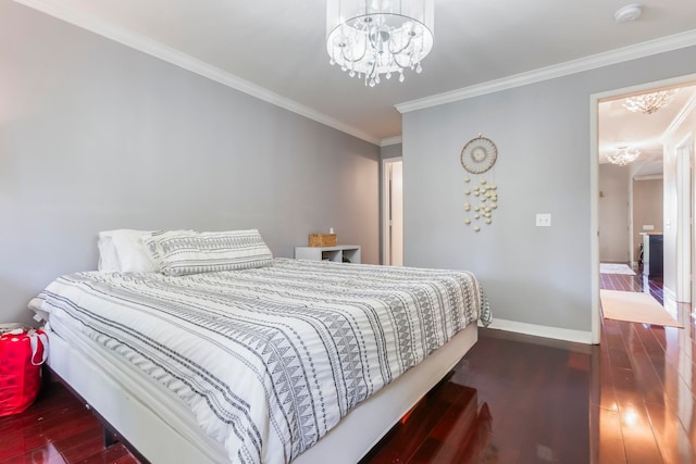 bedroom featuring dark wood-type flooring, crown molding, and a chandelier