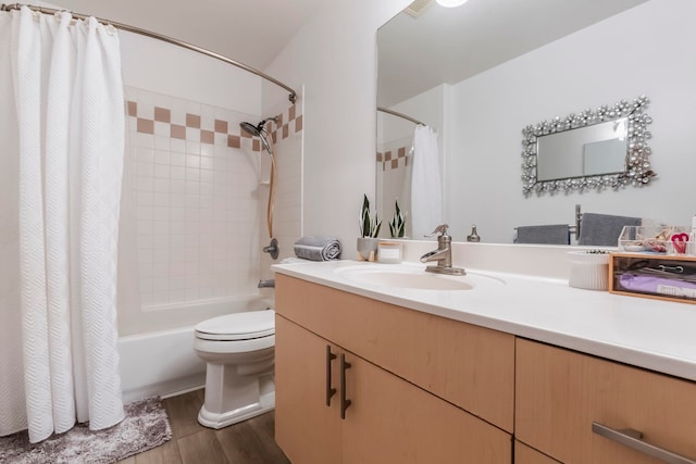 full bathroom featuring wood-type flooring, toilet, vanity, and shower / bath combo