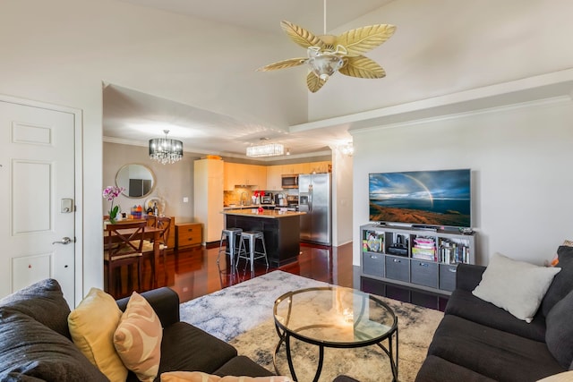 living room featuring ornamental molding, vaulted ceiling, dark hardwood / wood-style floors, and ceiling fan