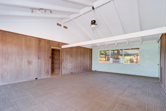 293 Manini Pl, Kihei, HI 96753 - spare room with beam ceiling, carpet flooring, cooling unit, and wood walls