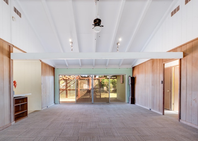 293 Manini Pl, Kihei, HI 96753 - unfurnished living room featuring lofted ceiling with beams, visible vents, carpet floors, and wood walls