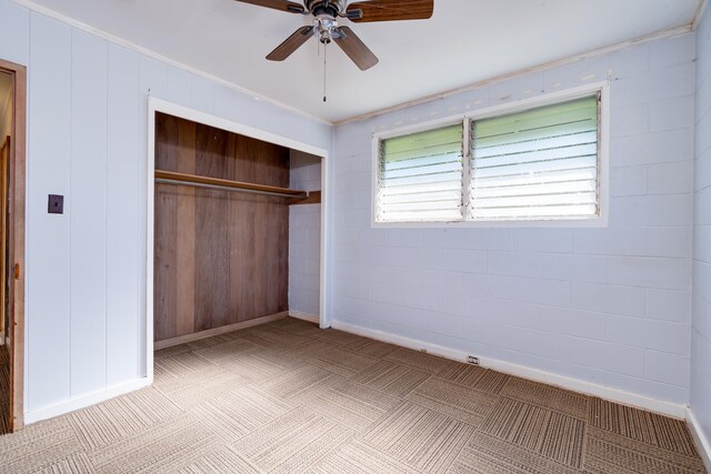 293 Manini Pl, Kihei, HI 96753 - unfurnished bedroom featuring a closet, ceiling fan, concrete block wall, and baseboards