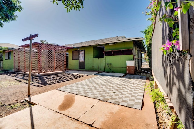 293 Manini Pl, Kihei, HI 96753 - rear view of house featuring fence, roof with shingles, concrete block siding, and a patio area