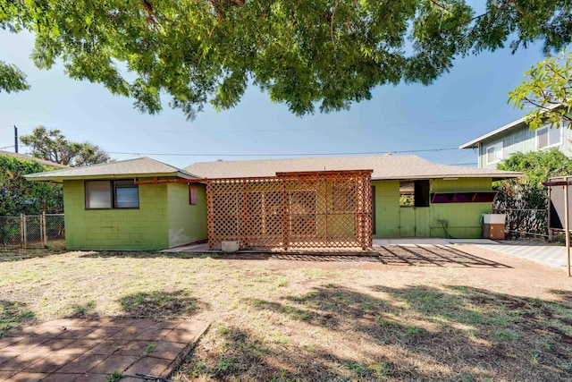 293 Manini Pl, Kihei, HI 96753 - rear view of property with concrete block siding, fence, a lawn, and roof with shingles