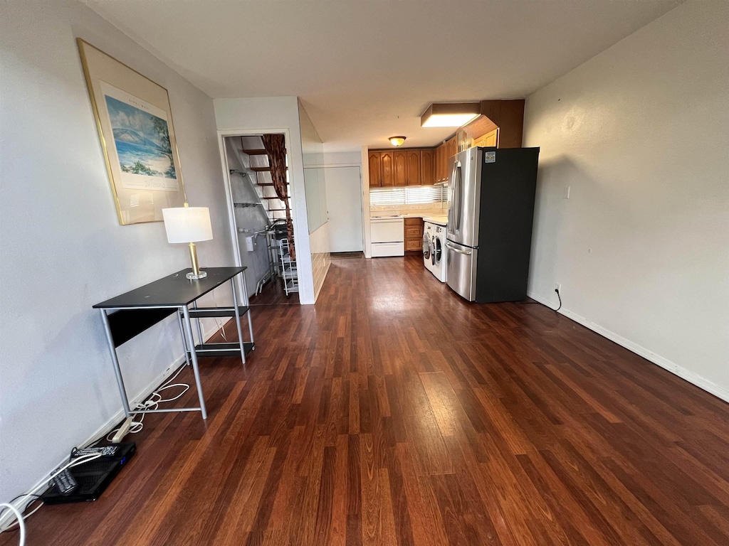 interior space with stainless steel refrigerator, dishwasher, and dark hardwood / wood-style flooring