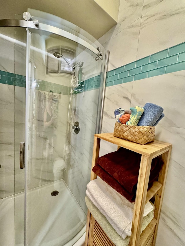 bathroom featuring a shower with shower door