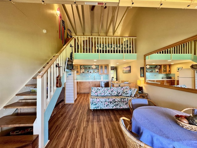 stairway featuring a high ceiling and hardwood / wood-style floors