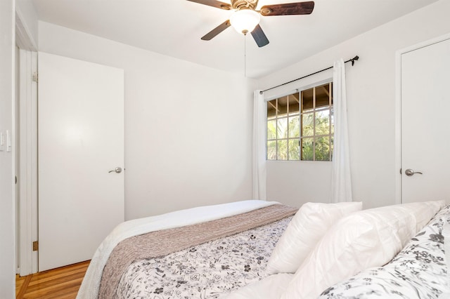 bedroom with ceiling fan and wood-type flooring