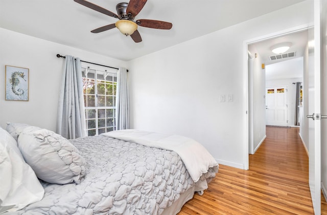 bedroom with light hardwood / wood-style floors and ceiling fan