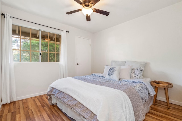 bedroom with ceiling fan and hardwood / wood-style flooring