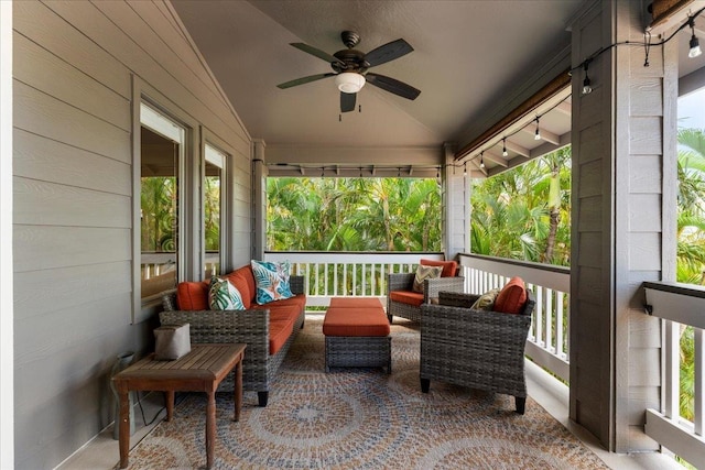 sunroom / solarium with lofted ceiling and ceiling fan