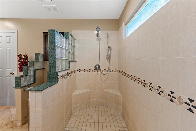 bathroom with tiled shower