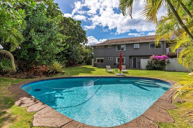 view of pool with a yard