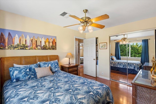 bedroom featuring wood-type flooring, ceiling fan, and a closet