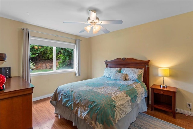 bedroom with ceiling fan and wood-type flooring