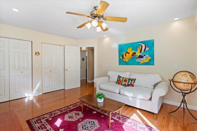 living room featuring hardwood / wood-style flooring and ceiling fan