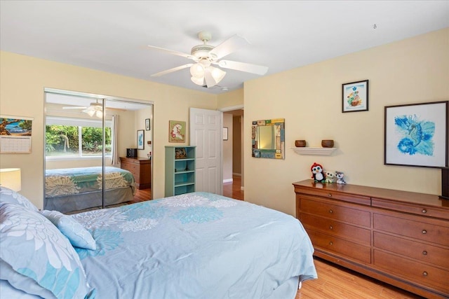 bedroom with ceiling fan, a closet, and light hardwood / wood-style floors