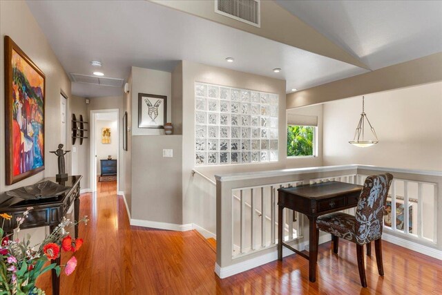 dining room featuring hardwood / wood-style flooring and vaulted ceiling