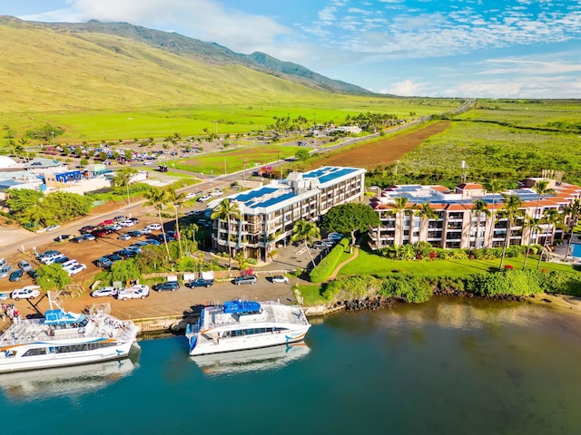 drone / aerial view featuring a water and mountain view