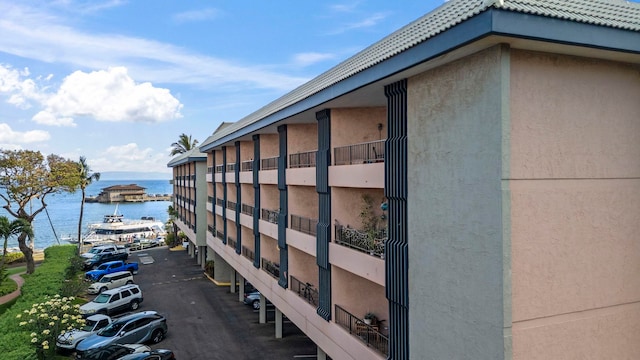 view of property exterior featuring stucco siding and a water view