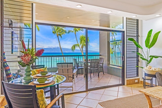 entryway featuring a water view and tile patterned flooring