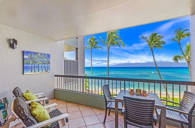 balcony featuring a water view and a view of the beach