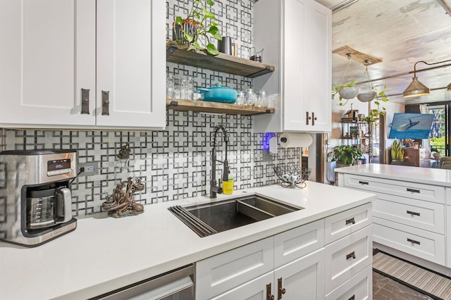 kitchen featuring light countertops, open shelves, a sink, and white cabinets